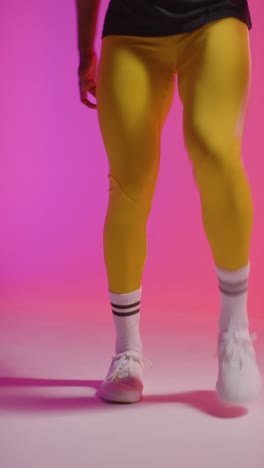 Vertical-Video-Close-Up-Of-Female-Footballer-Training-In-Vertical-Video-Studio-Playing-Keepy-Uppy-Kicking-Ball-1